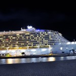 Oasis of the Seas all lit up at night while at port.