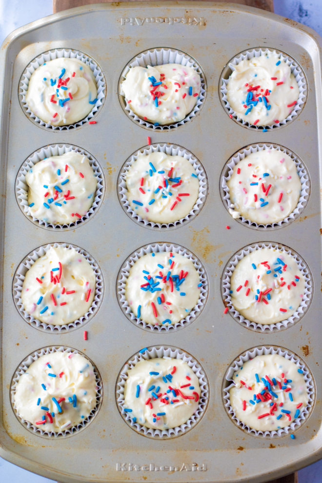 Red, White, and Blue Mini Cheesecakes Recipe ready to go in the oven with the sprinkles on top