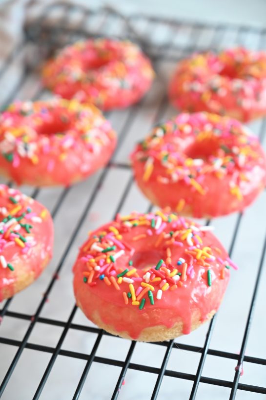 Vanilla-Glazed Baked Donuts is an easy recipe to give you familiar, old-fashioned dessert without all the hassle of rolling, cutting, and frying the dough. These donuts will remind you just how delicious breakfast or brunch can be!