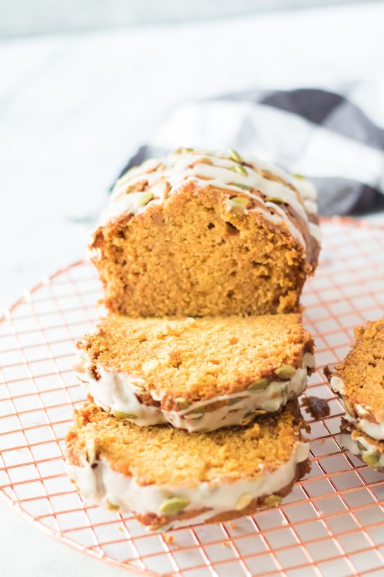 Maple-Glazed Pumpkin Bread is an easy holiday recipe teaching you how to make a moist, fresh pumpkin bread from scratch. This bread is drizzled with a simple maple glaze and each slice of this bread is so delicious for fall.